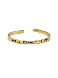 Fair Anita Breathe Cuff in brass, stamped Inhale. Exhale. Repeat.