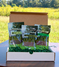Fair Trade Chocolate Sampler Gift Box, open to show three bags of chocolate pecan bark