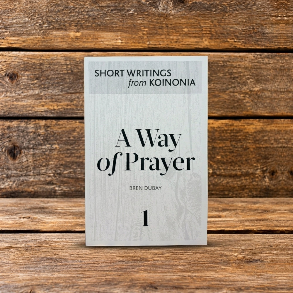 Front cover of A Way of Prayer, featuring a book displayed upright against a rustic wooden background.