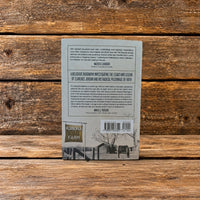 Back cover of Clarence Jordan: A Radical Pilgrimage in Scorn of the Consequences, displayed against a rustic wooden background.