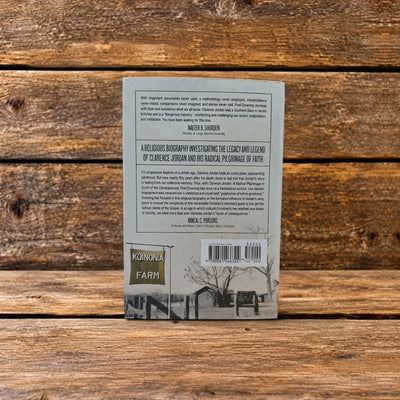 Back cover of Clarence Jordan: A Radical Pilgrimage in Scorn of the Consequences, displayed against a rustic wooden background.