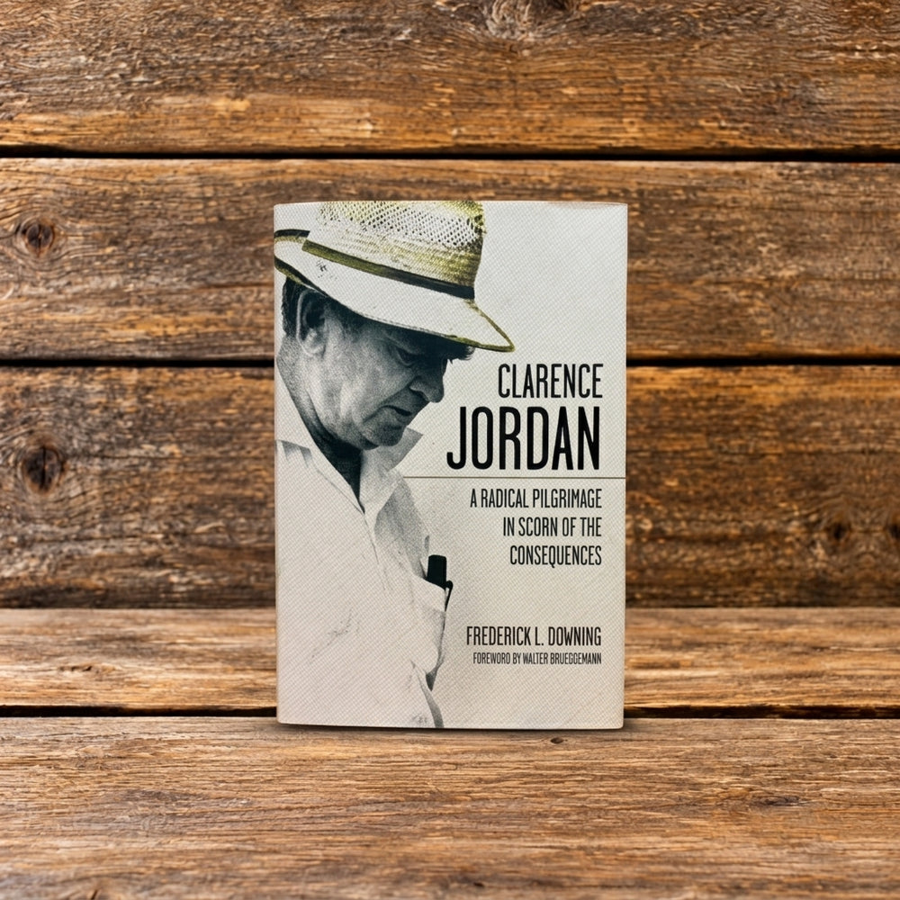 Front cover of Clarence Jordan: A Radical Pilgrimage in Scorn of the Consequences, featuring a historic photograph on the book cover, photographed on a rustic wooden surface.