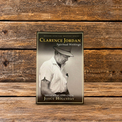 Front cover of Clarence Jordan: Spiritual Writings, featuring a black-and-white photograph of Clarence Jordan, displayed against a rustic wooden background.