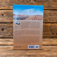 Back cover of Clarence Jordan's Cotton Patch Gospel: The Complete Collection, featuring a cotton field photograph, book description, and barcode, displayed against a rustic wooden plank background.