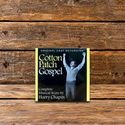 Front cover of Cotton Patch Gospel musical CD by Harry Chapin, displayed against a rustic wooden background.