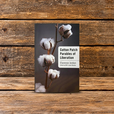 Front cover of Cotton Patch Parables by Clarence Jordan, featuring an illustrated book cover, photographed on a rustic wooden surface.