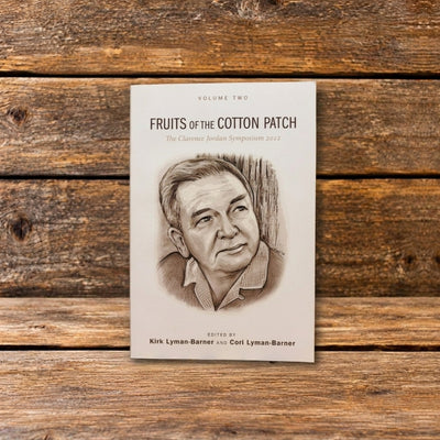 Front cover of Fruits of the Cotton Patch, Volume 2, with a pencil drawing of Clarence Jordan displayed against a rustic wooden background.