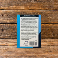 Back cover of The Inconvenient Gospel by Clarence Jordan, featuring a description of his teachings, endorsements, publisher information, and barcode, photographed on a rustic wooden surface.